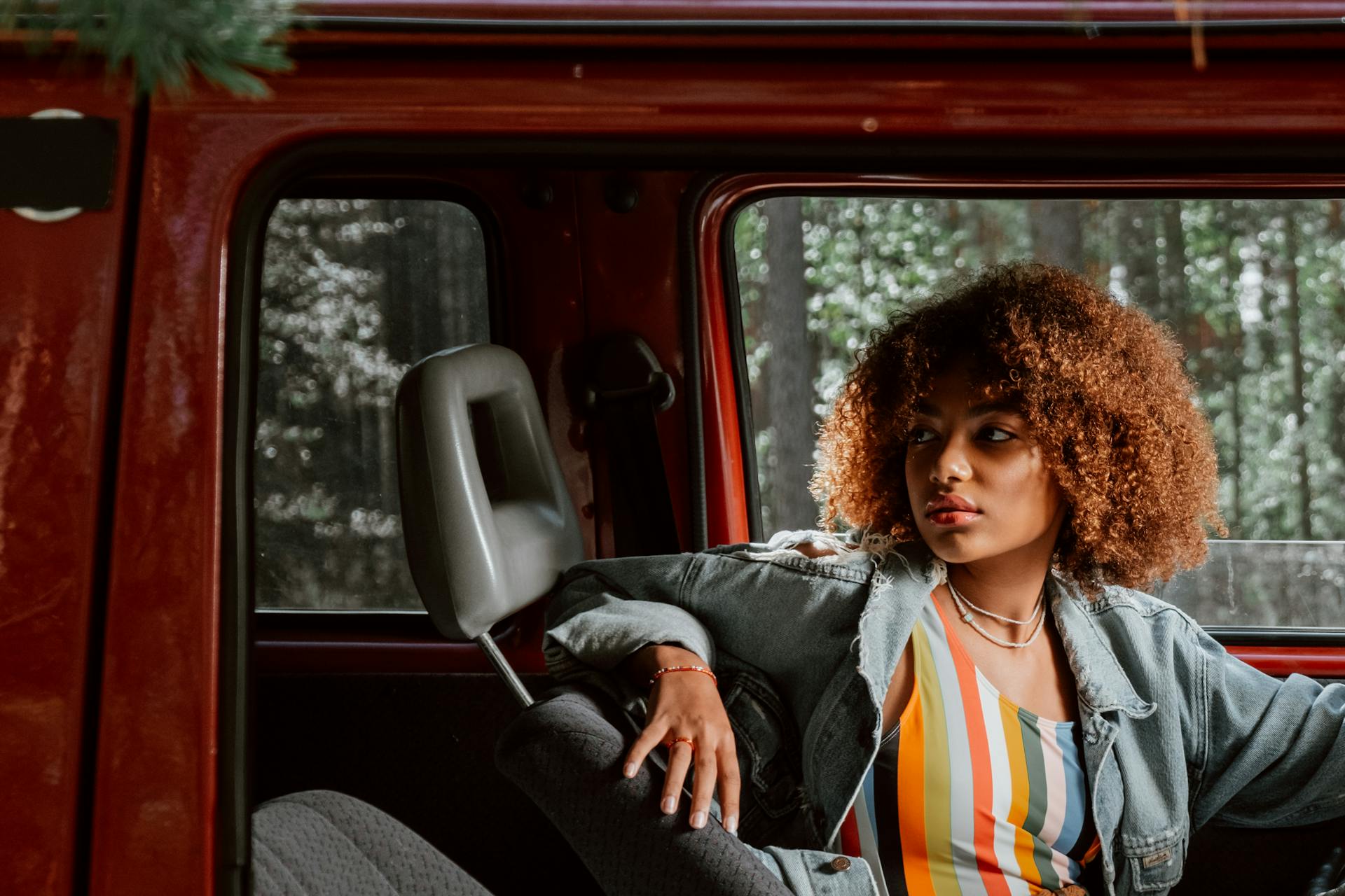 girl examining a car